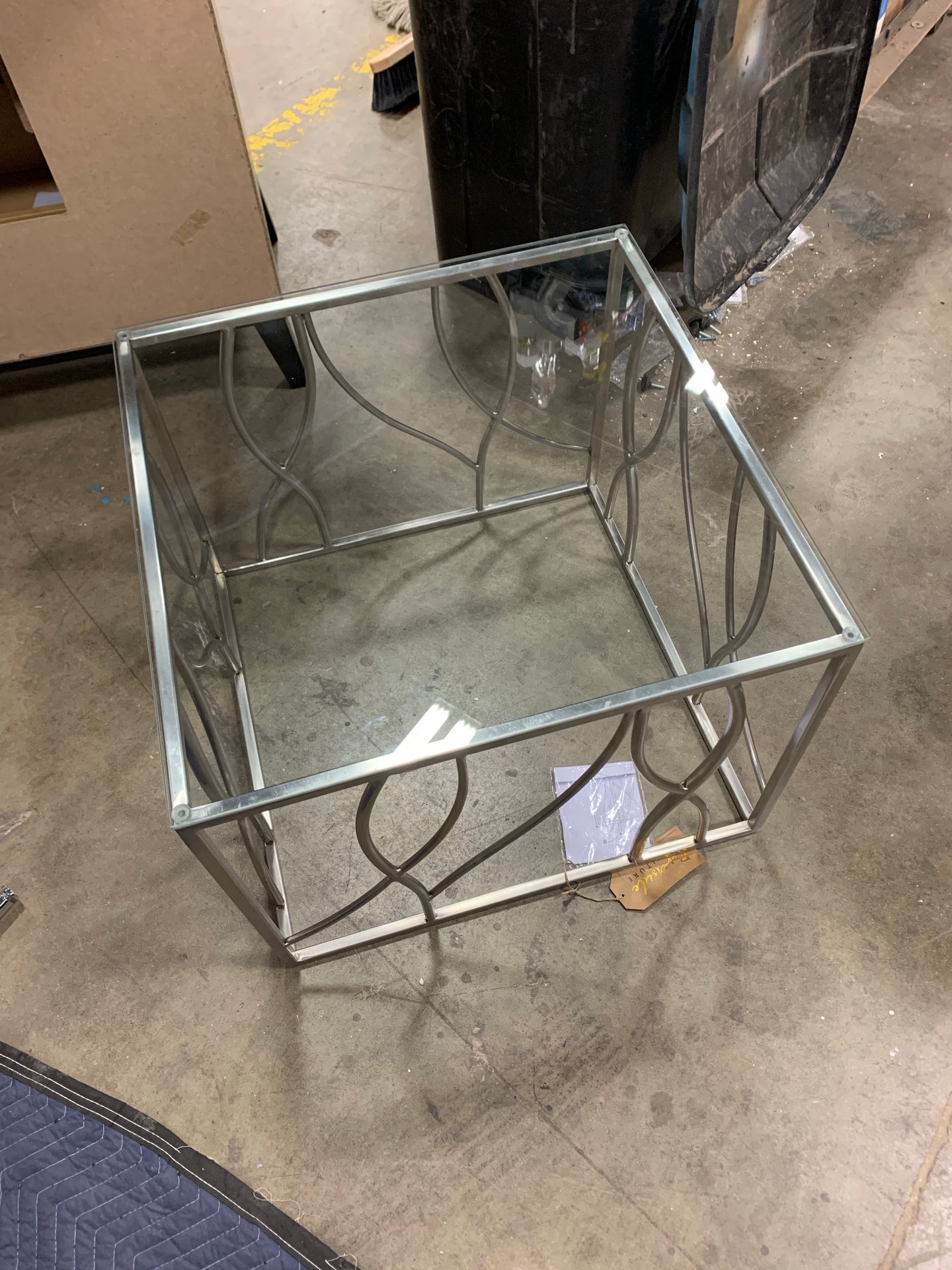 Coffee table with glass top and silver base